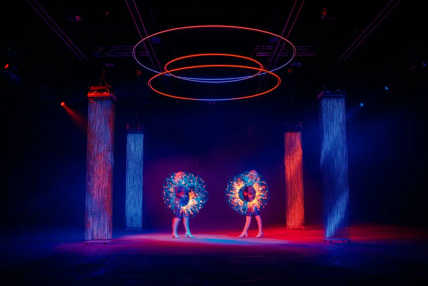 Performers under suspended light rings